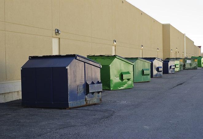 tilted front-load dumpsters being emptied by waste management workers in Converse